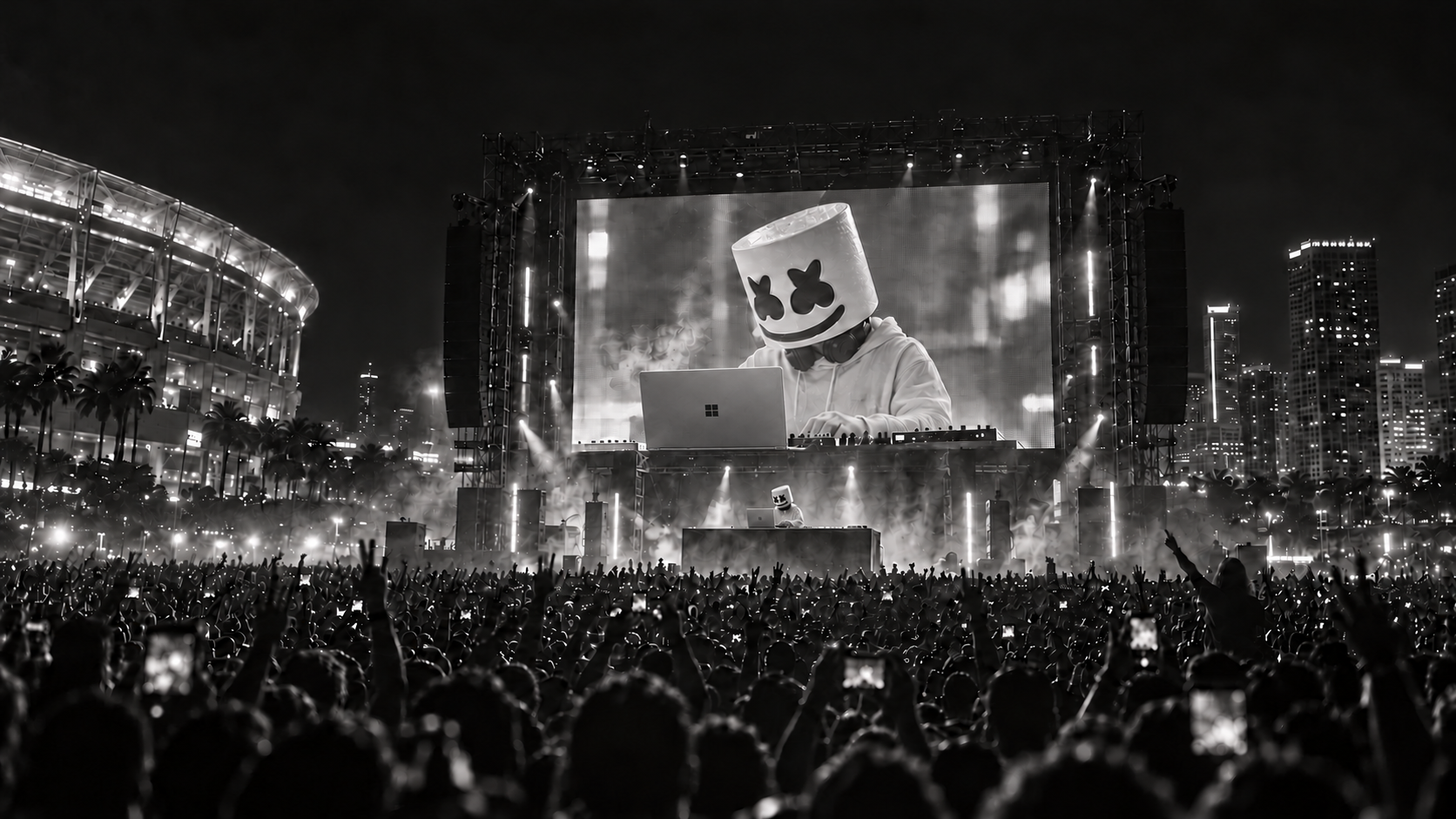 Concept: Marshmello performs with an open Surface directly in front of him on the DJ booth. The large LED wall shows the matching workstation and a full-sized, realistically proportioned Surface laptop in close-up above a cheering afterparty crowd.