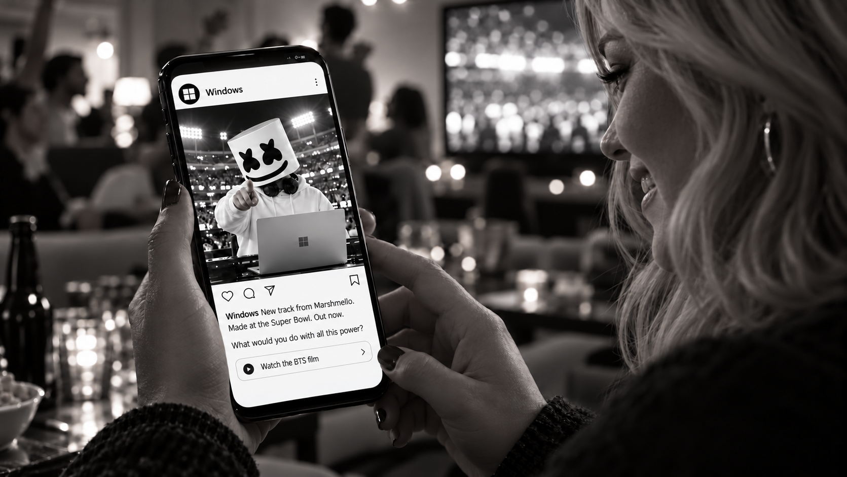 Concept: a blonde fan at a Super Bowl party views a Windows Instagram post announcing Marshmello’s new track made at the game. The post asks, What would you do with all this power? and invites her to watch the BTS film.